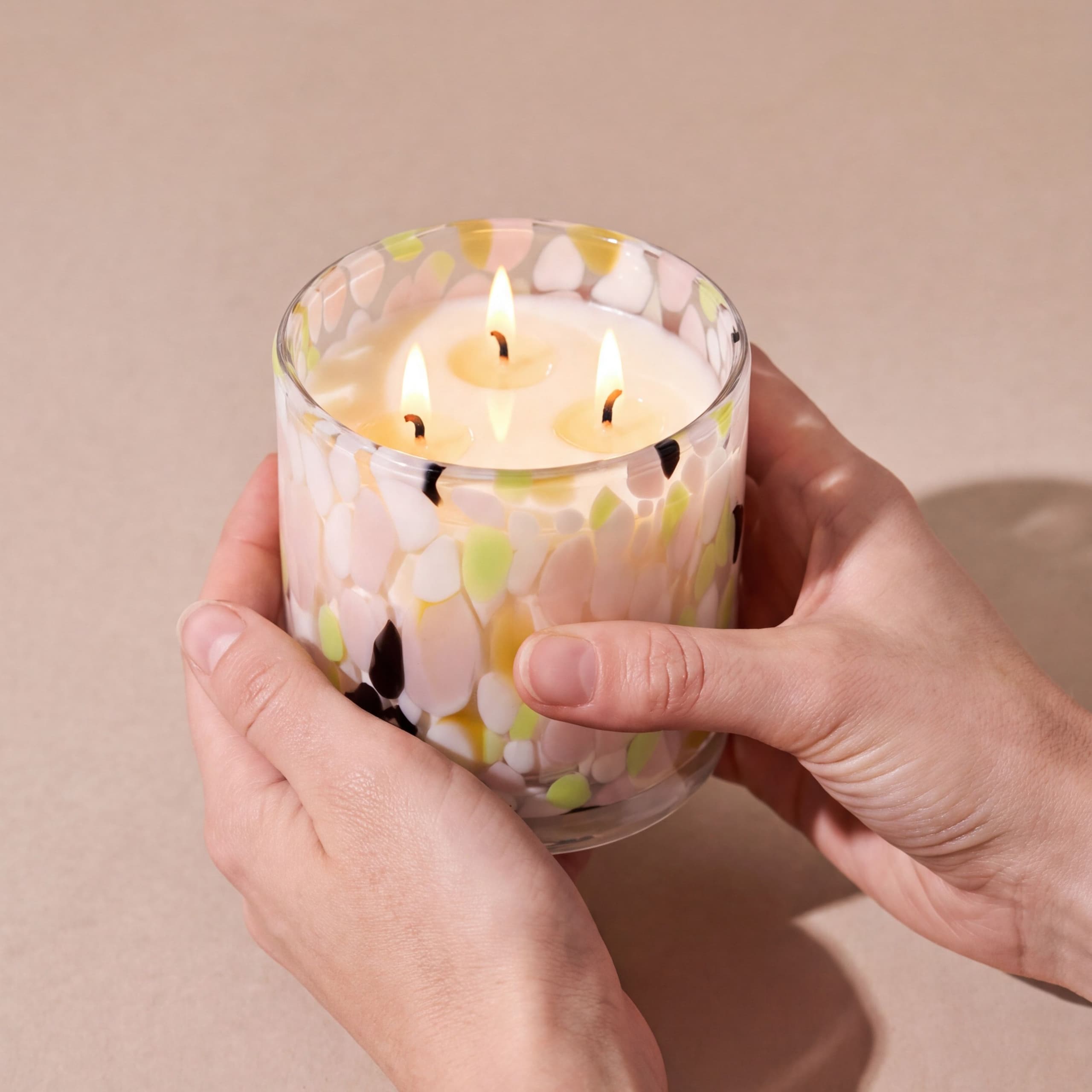 The Seductive Candle, lit and held in two hands to show its size